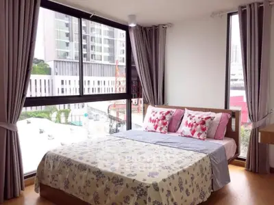 Bright bedroom with large windows and modern decor in urban apartment