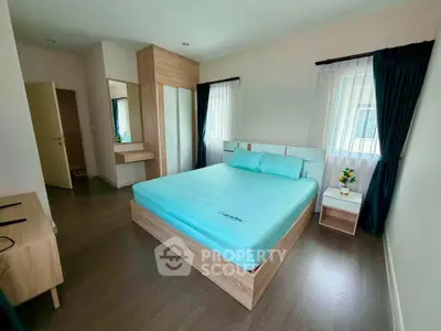 Spacious bedroom with modern wooden furniture and natural light