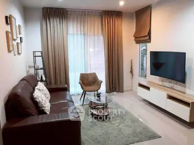 Modern living room with sleek furniture and wall-mounted TV