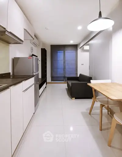 Modern open-plan kitchen and living area with sleek design and ample natural light.