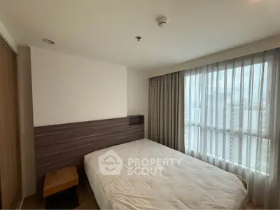 Modern bedroom with large window and stylish wooden accents