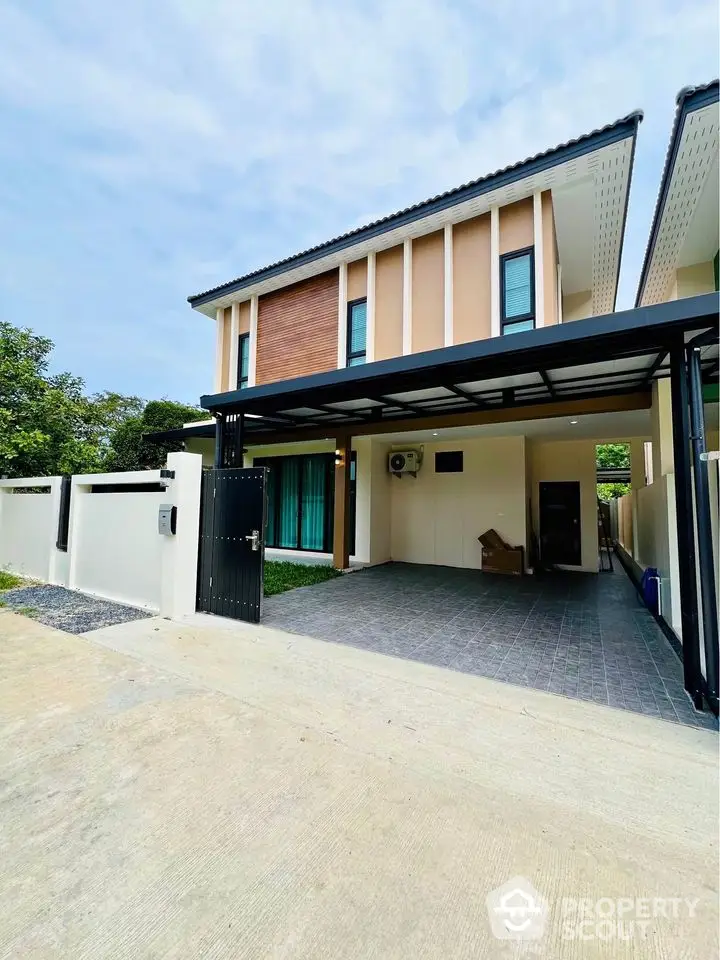 Modern two-story house with spacious driveway and sleek exterior design