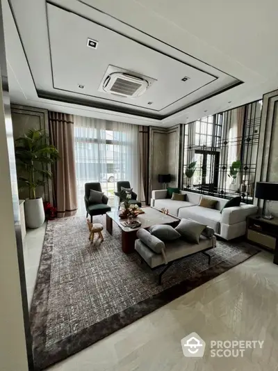 Elegant living room with modern furnishings, polished marble flooring, and sophisticated ceiling design, complemented by ample natural light and tasteful decor.