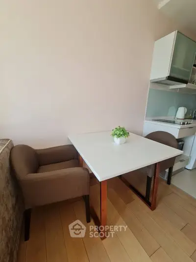 Cozy kitchen corner with modern table and chairs, perfect for small apartments.