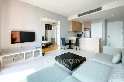 Spacious modern living room with open kitchen and sleek furniture