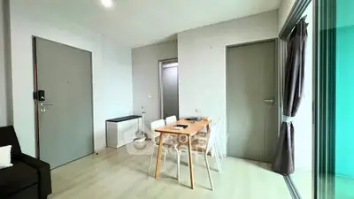 Modern apartment interior with dining area and large windows
