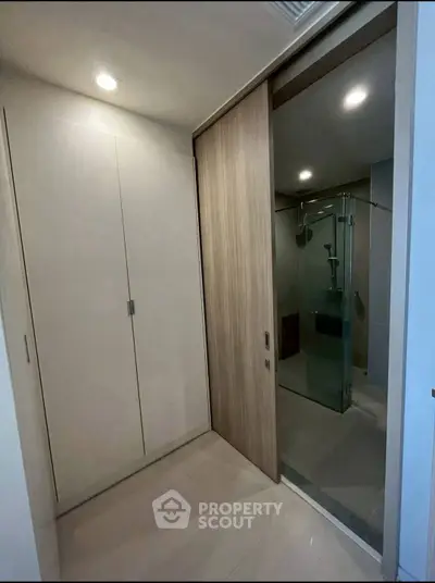 Modern bathroom with glass shower and sleek storage cabinets