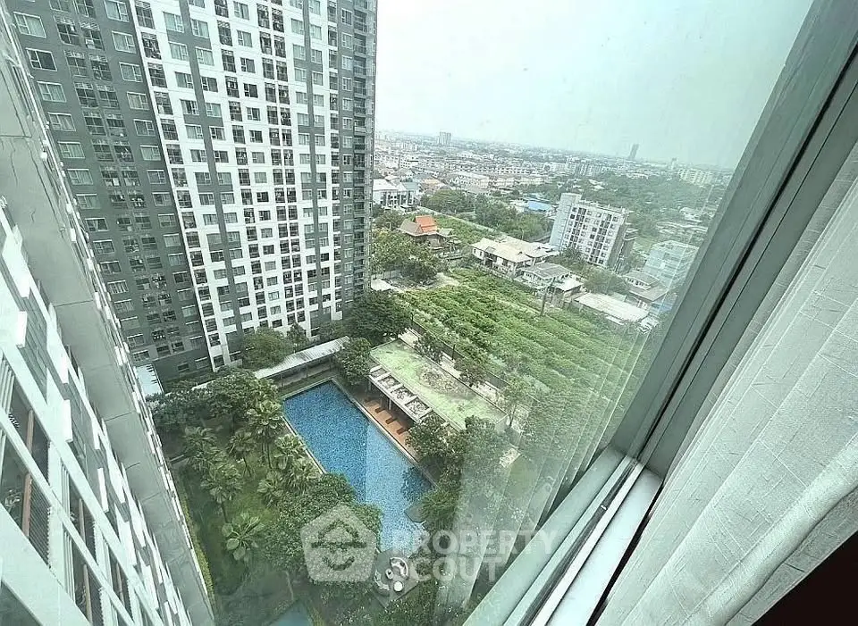 Stunning high-rise apartment view with pool and cityscape, perfect for urban living.