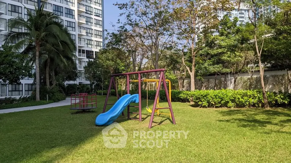 Spacious garden with playground in modern residential complex