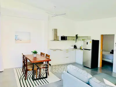 Modern open-plan kitchen and dining area with sleek appliances and stylish decor.