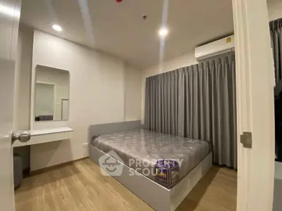 Modern bedroom with sleek design, featuring a comfortable bed and stylish decor in a cozy apartment.