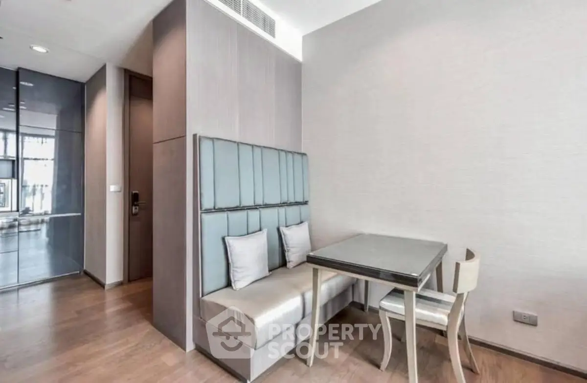 Modern dining nook with built-in seating and sleek table in stylish apartment interior.