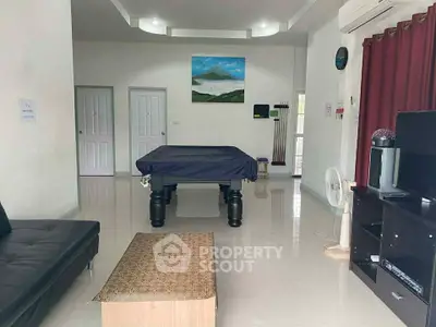 Spacious living room with pool table and modern decor