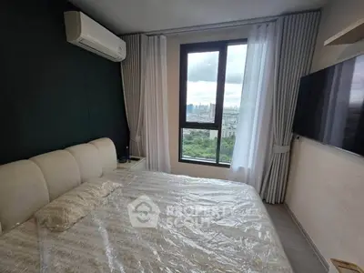 Modern bedroom with large window offering stunning city view, featuring sleek design and comfortable furnishings.