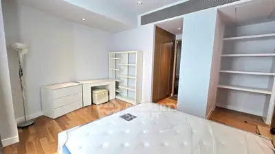Spacious bedroom with modern furnishings and ample storage space
