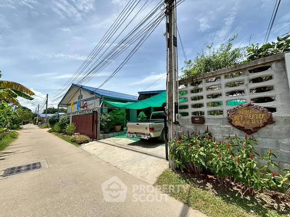 Charming residential property with lush garden and driveway in serene neighborhood.