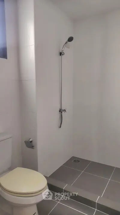 Modern minimalist bathroom with sleek shower and tiled flooring