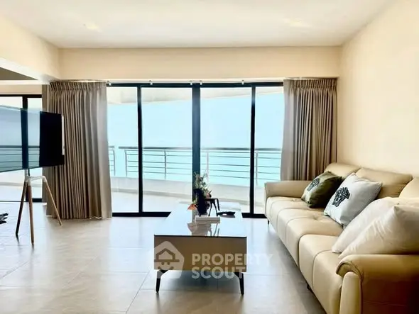 Spacious living room with ocean view and modern decor in luxury apartment