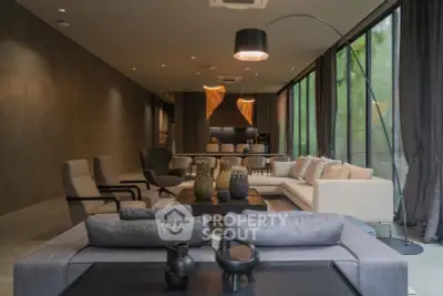 Luxurious modern living room with elegant decor and large windows offering natural light.