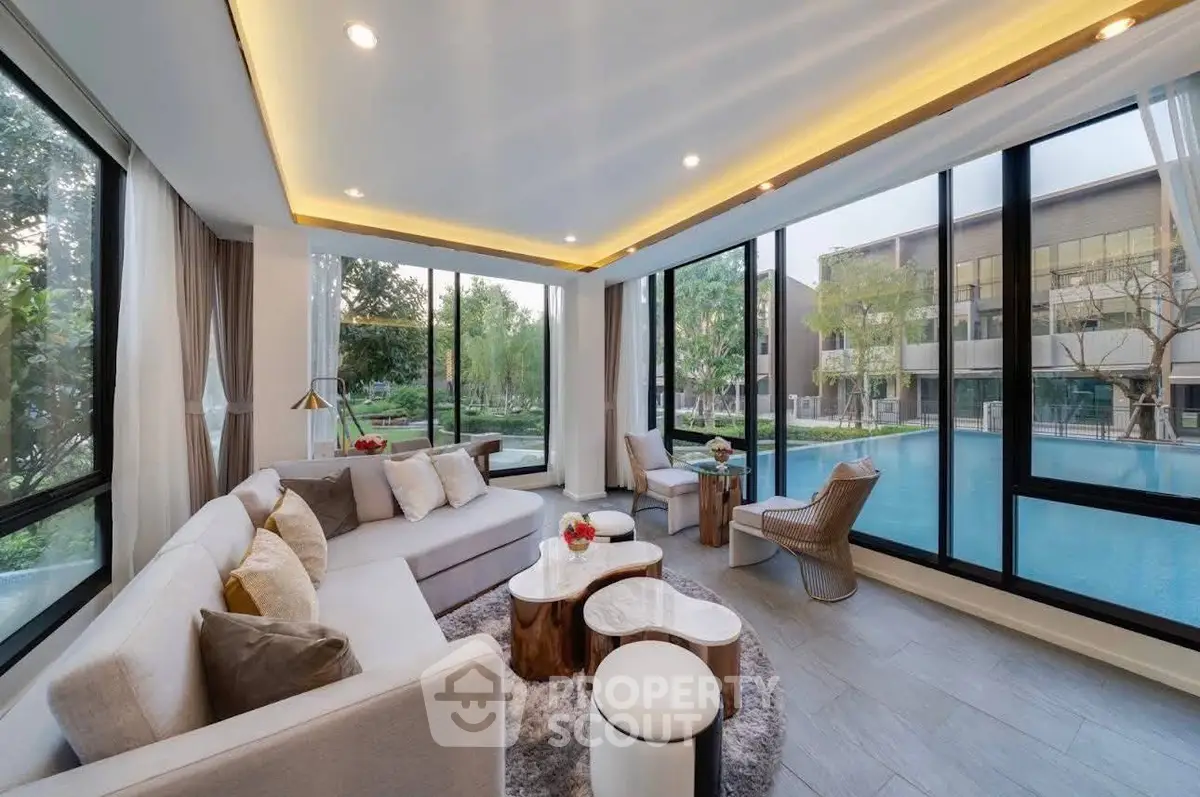 Luxurious living room with pool view and modern decor in upscale property