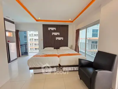 Modern bedroom with twin beds and balcony view in a stylish apartment