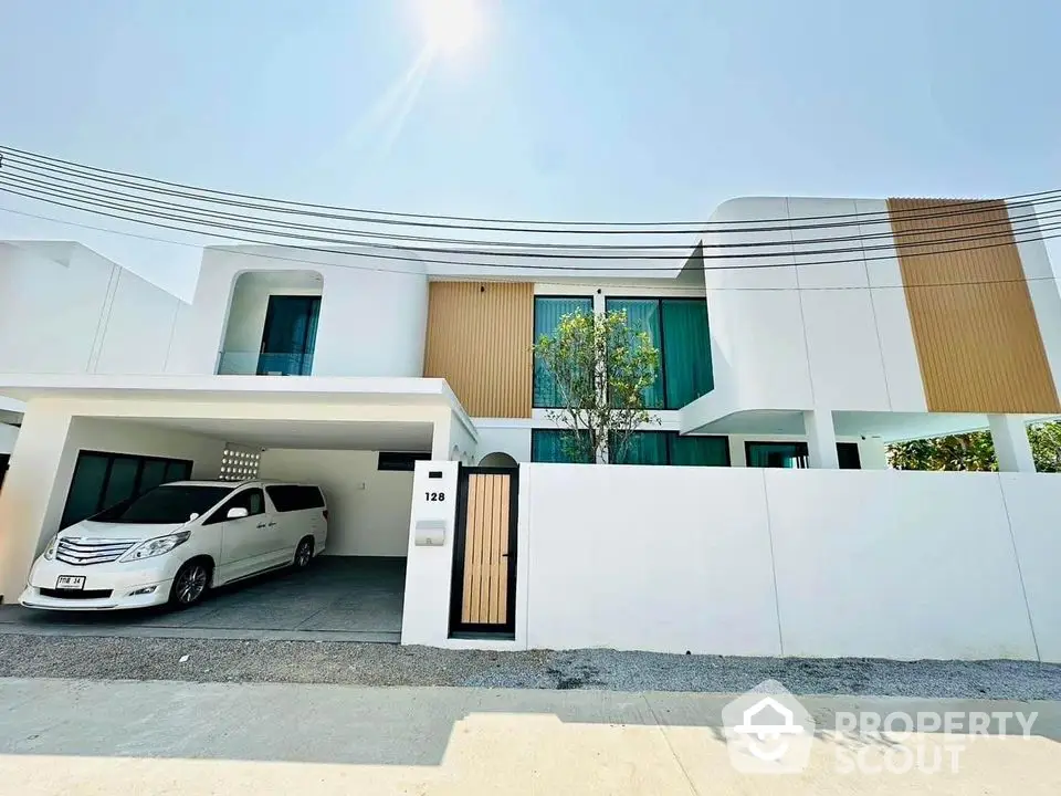 Modern white two-story house with carport and sleek design