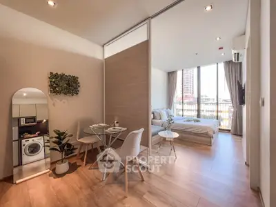 Modern studio apartment with open layout, featuring a cozy bedroom and compact dining area.