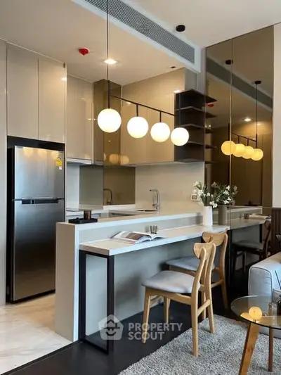 Modern kitchen with sleek design, featuring open layout and stylish lighting, perfect for contemporary living.