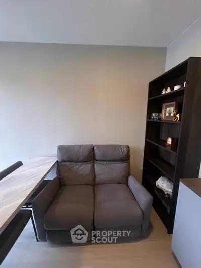 Cozy living room with plush sofa and elegant shelving unit, perfect for relaxation and storage.