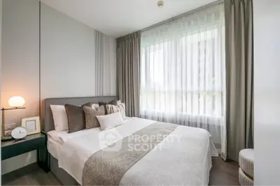 Elegant bedroom with modern decor and large window for natural light