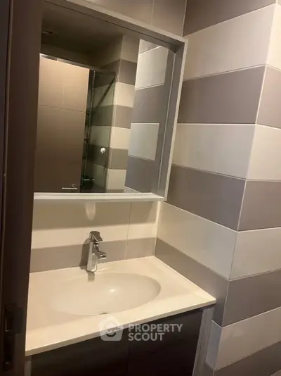 Modern bathroom with sleek sink and stylish tile design