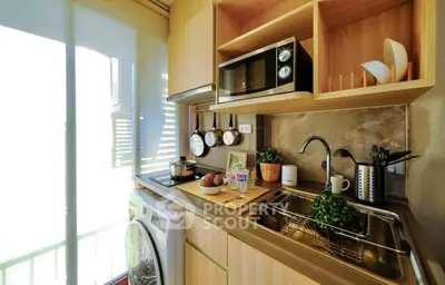 Charming compact kitchen with modern appliances and natural light