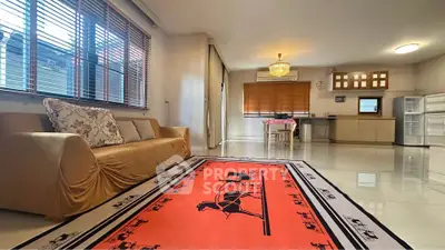 Spacious living room with modern kitchen and stylish decor in open layout apartment.