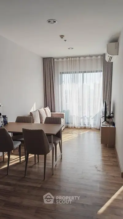 Bright modern living room with wooden flooring and large window view