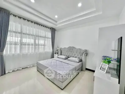 Spacious modern bedroom with elegant decor and natural light