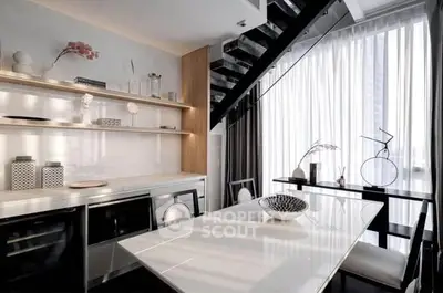 Modern kitchen with sleek design and open layout under staircase