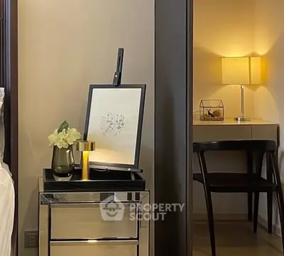 Elegant bedroom corner with mirrored nightstand and cozy study nook