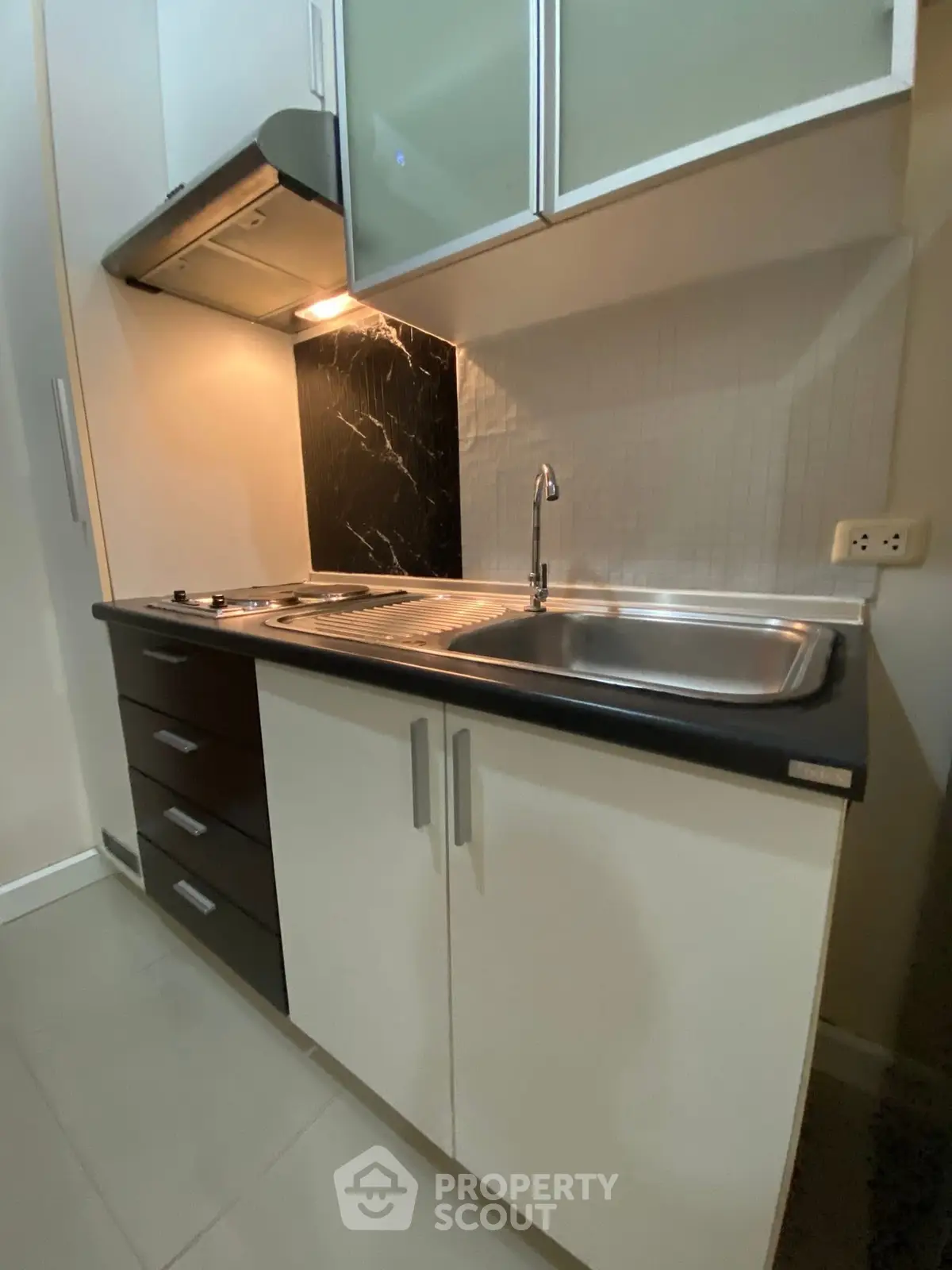 Compact modern kitchen with sleek cabinetry and stainless steel sink
