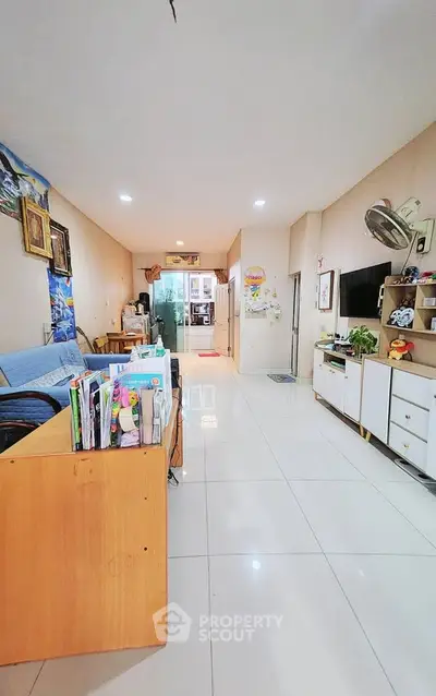 Spacious living room with modern decor and ample natural light