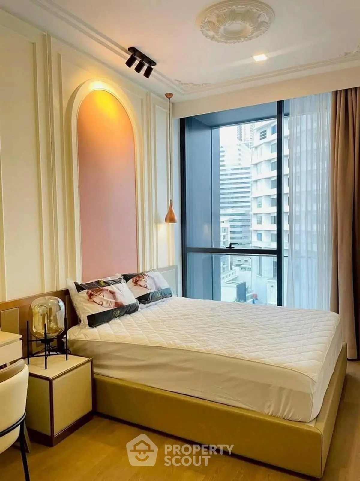 Luxurious bedroom with modern design and city view, featuring elegant lighting and stylish decor.