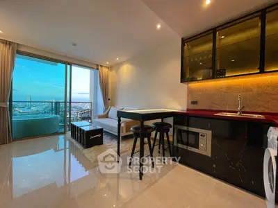 Luxurious open-plan living room with modern kitchen and stunning city view from balcony.