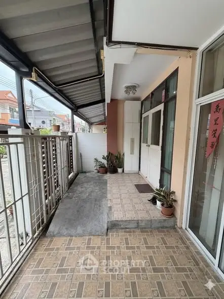 Charming entrance with tiled flooring and potted plants, perfect for welcoming guests.