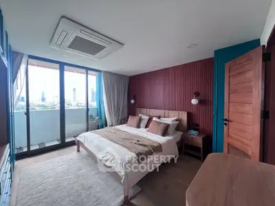 Luxurious bedroom with city view and modern decor in high-rise apartment.