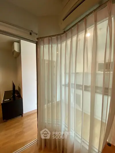 Modern apartment interior with glass partition and wooden flooring