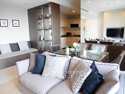 Modern living room with stylish decor and open kitchen layout in a contemporary apartment.