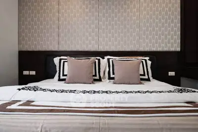 Luxurious bedroom with elegant decor and plush bedding in modern real estate property.