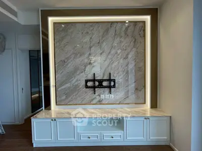 Luxurious living room with elegant marble feature wall and built-in cabinetry