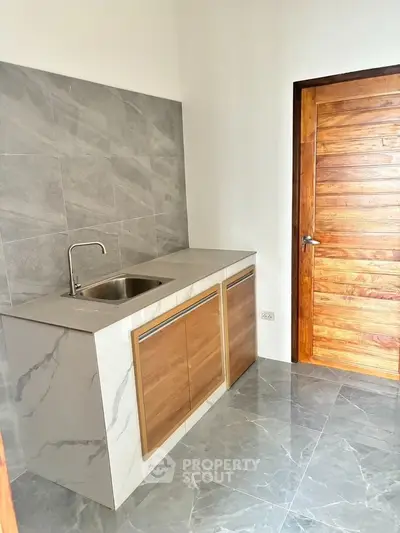 Modern kitchen with sleek marble countertops and wooden cabinetry