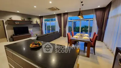 Spacious open-plan living and dining area with modern decor and garden view.