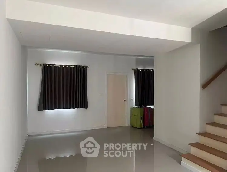 Spacious empty living room with staircase and modern design